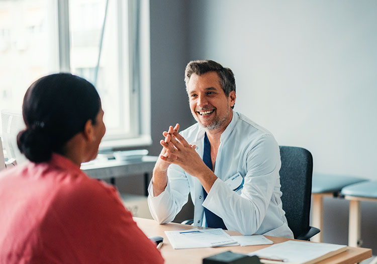 male doctor at desk with patient